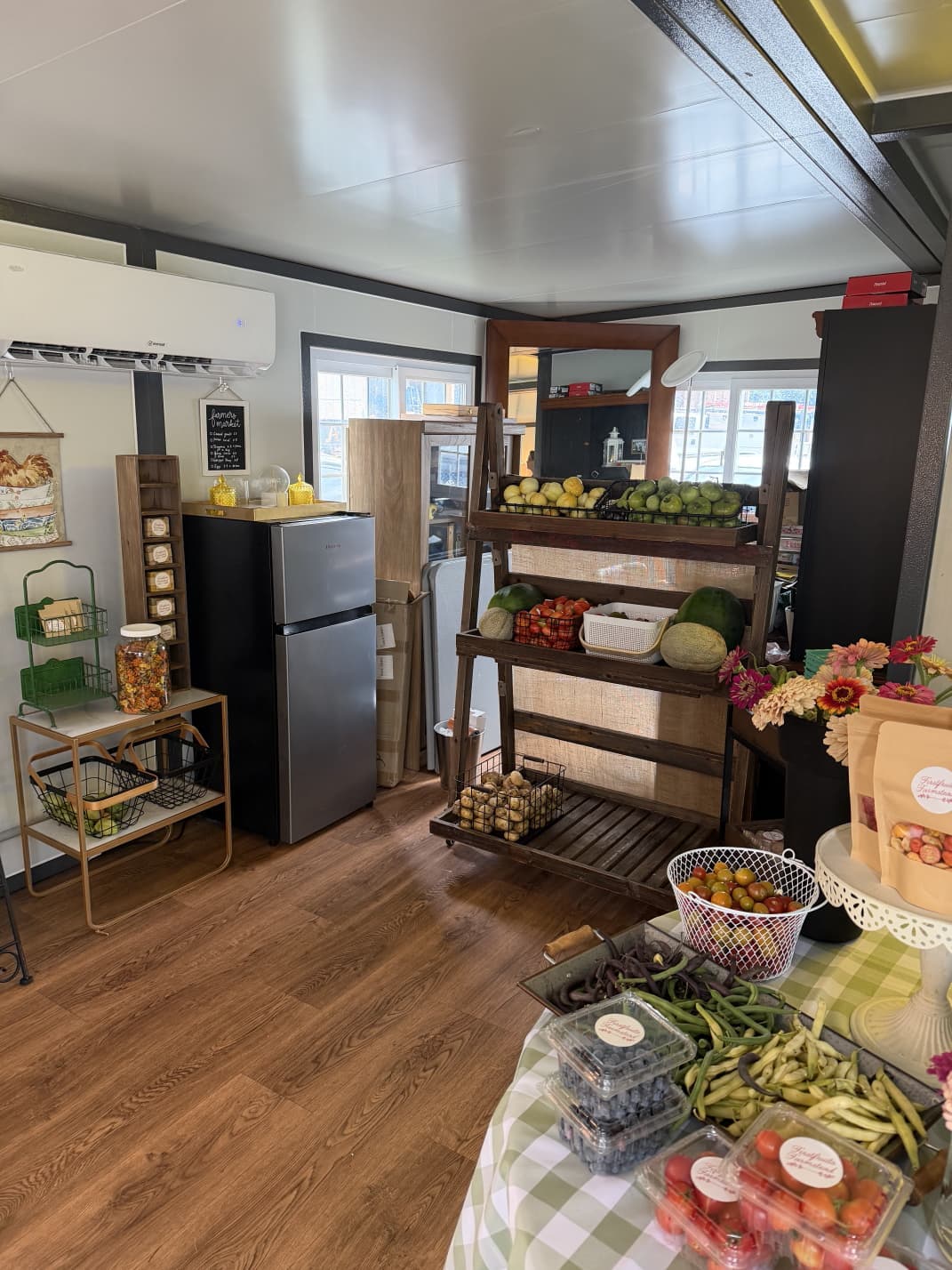 Inside the Firstfruits Farmstead farm shop with produce displays and fresh flowers